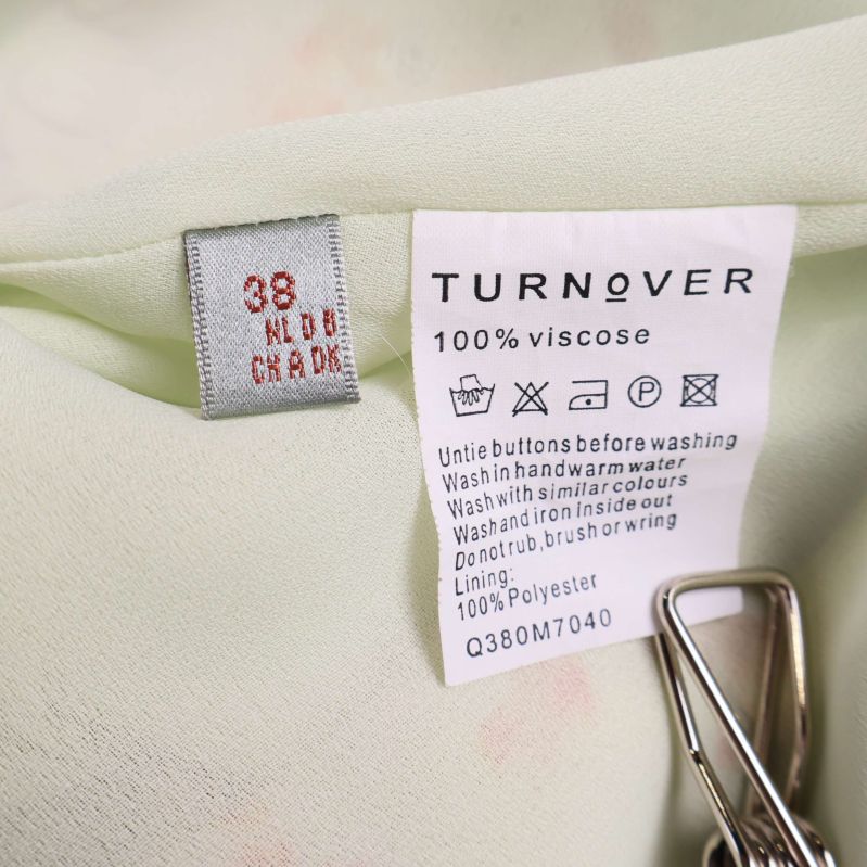 Materiallapp visar 100% viskos, storlek 38 och tvättråd