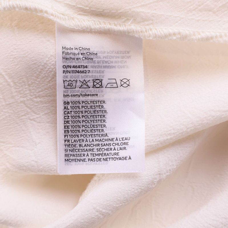 Materialetikett i klänningen som visar 100% polyester