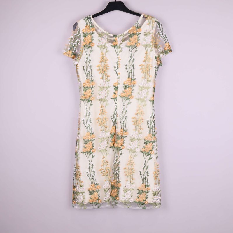 Helbild av ärmlös klänning med blommiga broderier framifrån