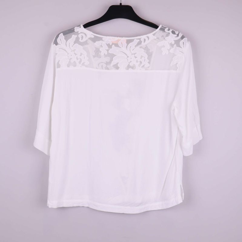 Vit topp sedd bakifrån med spets upptill