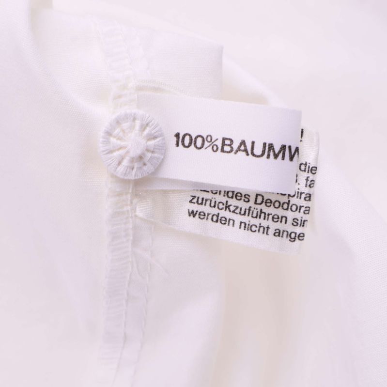 Materiallapp med text 100% bomull i blusen