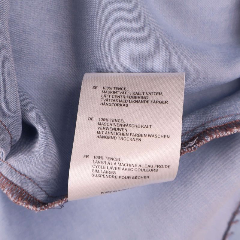 Tvättlapp ljusblå klänning visar 100% tencel