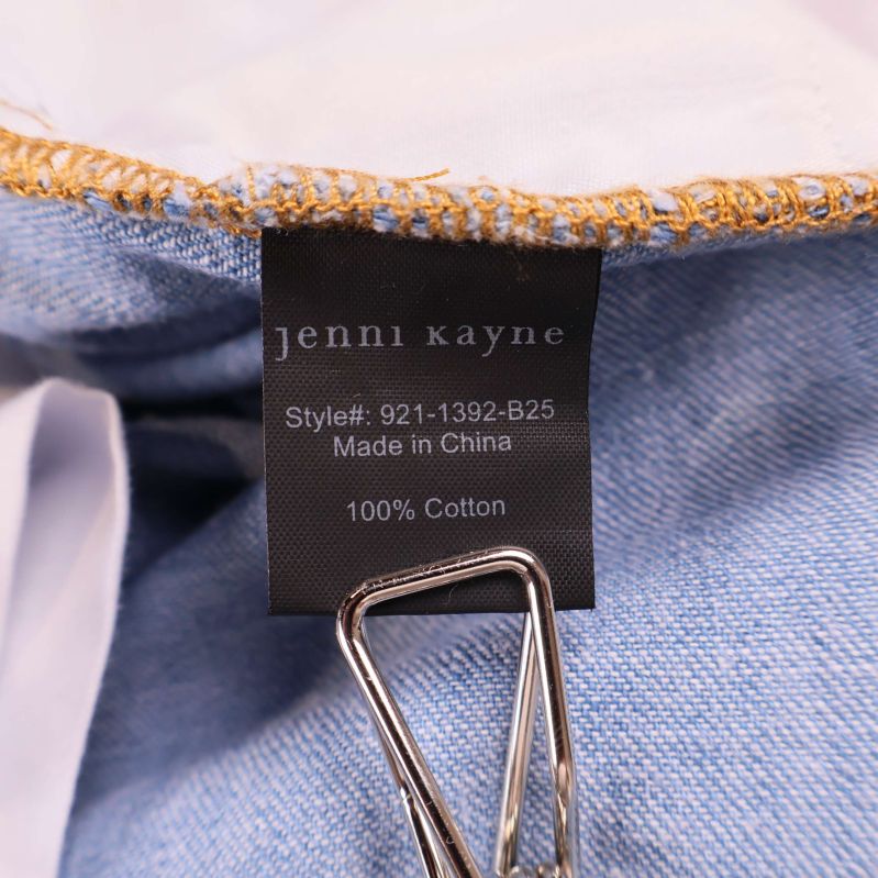 Materialetikett med texten 100% Cotton och jenni kayne