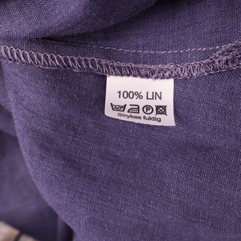 Materiallapp som visar 100% lin