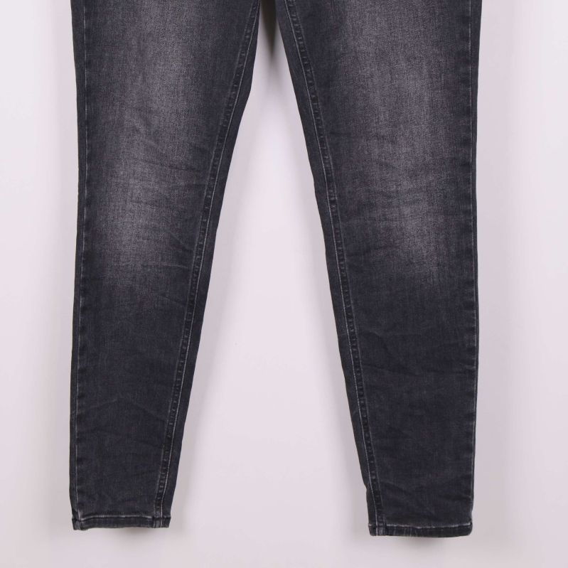 Benavslut på smala svarta jeans med lätt slitning
