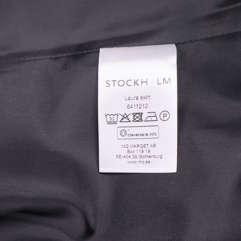 Vård- och tvättetikett för kjolen från STOCKH LM