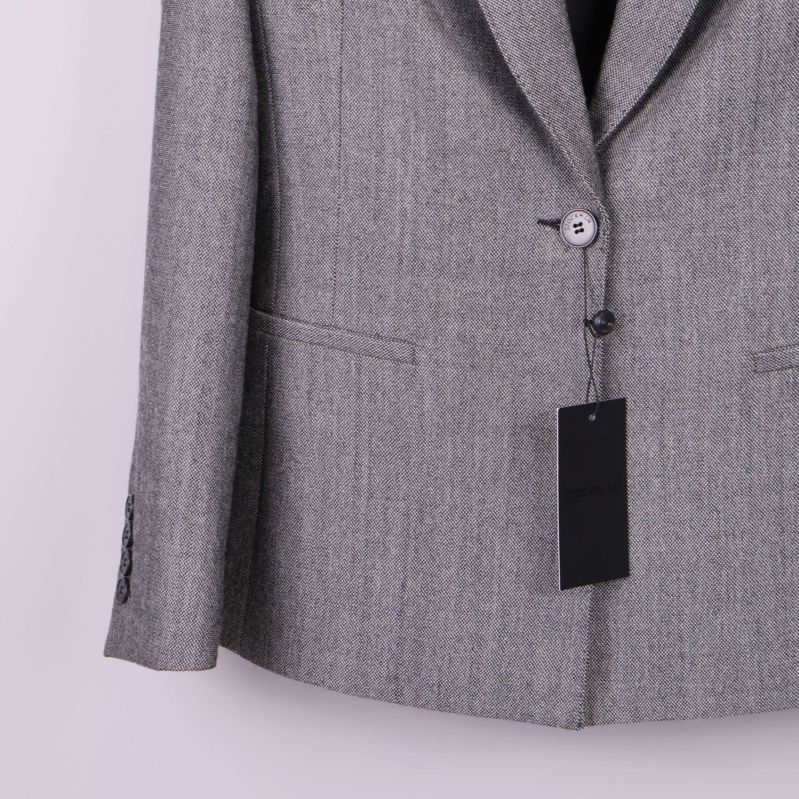 Närbild på blazer nedre framstycke och knapp