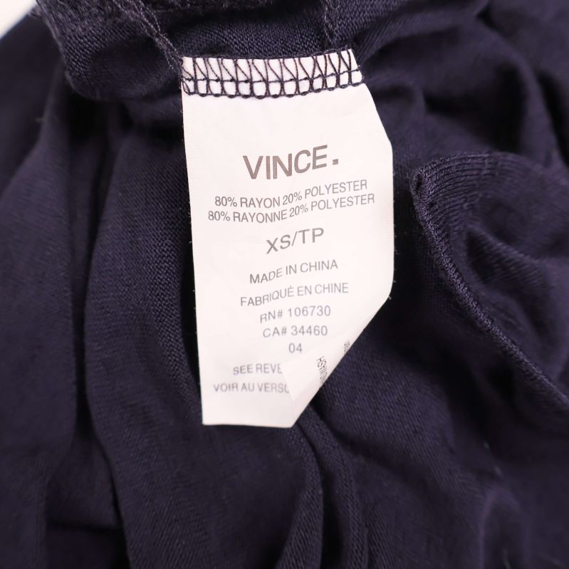 Materialetikett visar 80 procent rayon och 20 procent polyester
