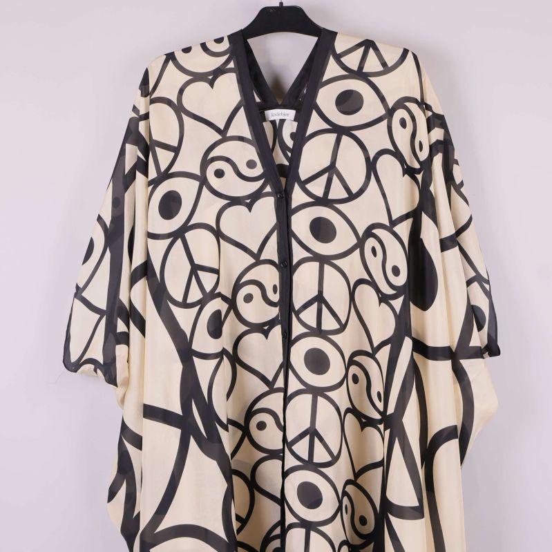 Överkropp och ärm på kaftan med svart kant