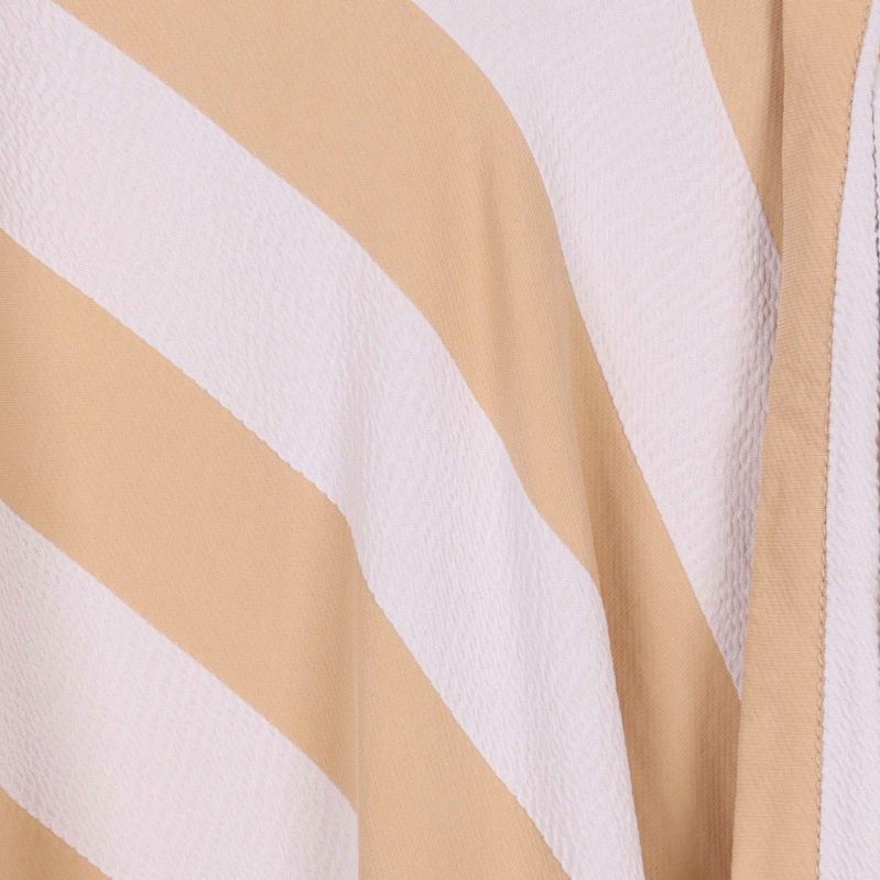 Närbild på randigt tyg i beige och vitt