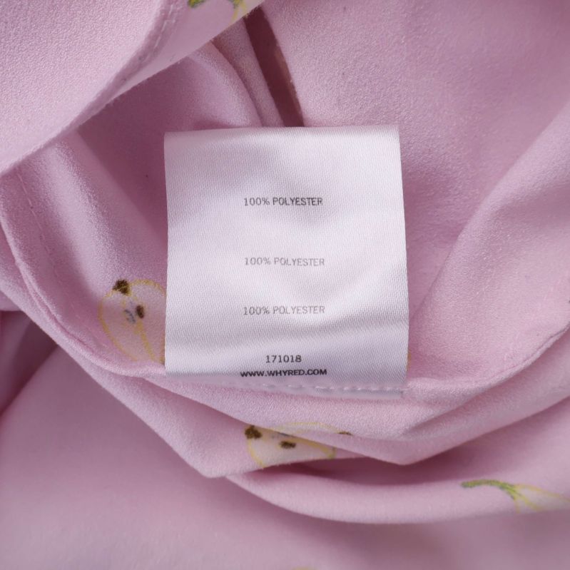 Etikett som visar materialet 100% polyester flera gånger