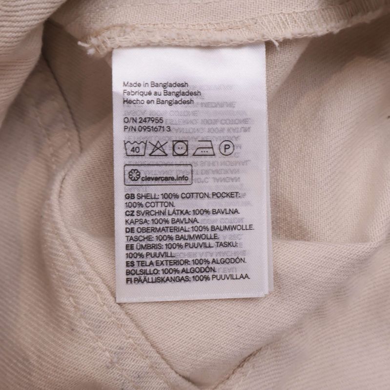 Material- och tvättrådsetikett med 100% bomullsinformation