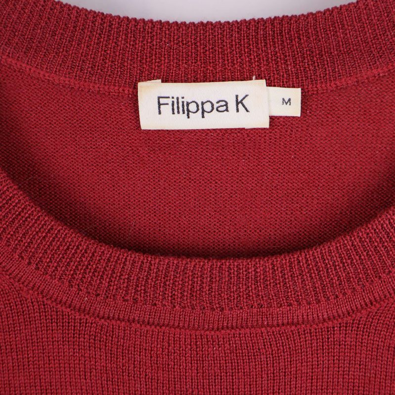 Närbild av Filippa K etikett i halsen på tröjan