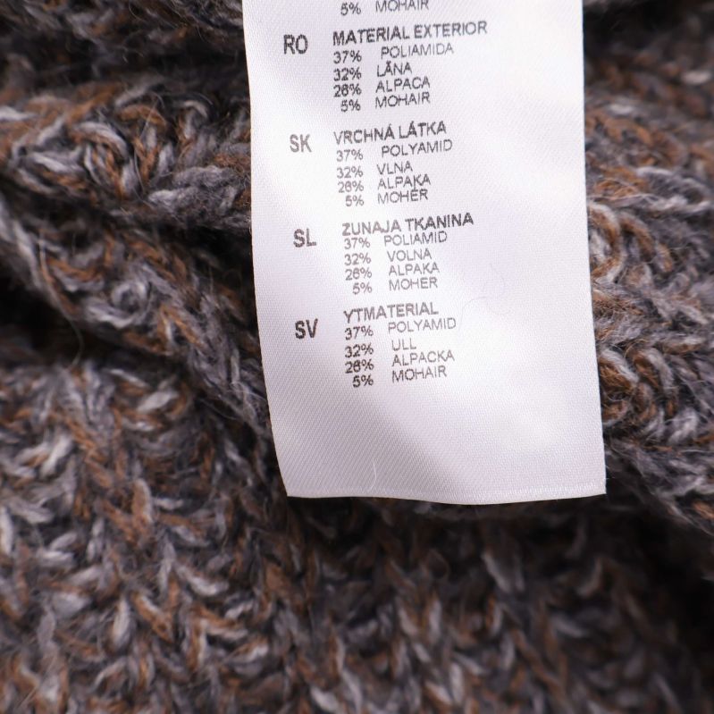 Materialetikett på svenska visar 37% polyamid, 27% ull, 23% alpacka, 9% mohair