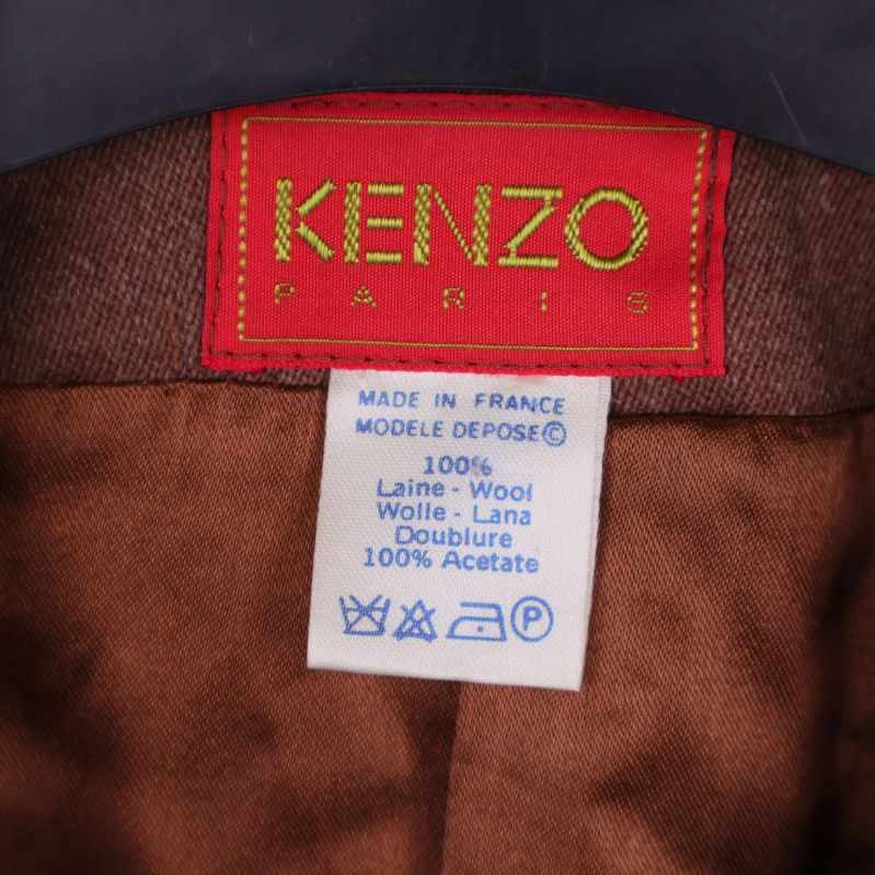 Närbild på Kenzo Paris etikett och materiallapp med ull och acetat