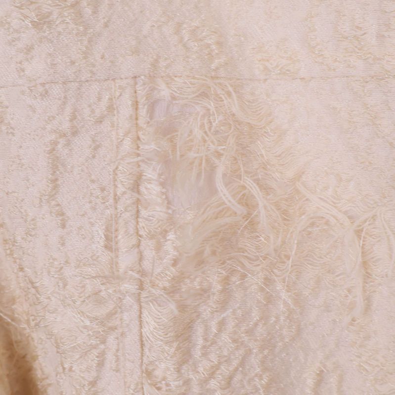 Detalj av materialets fransiga struktur i närbild