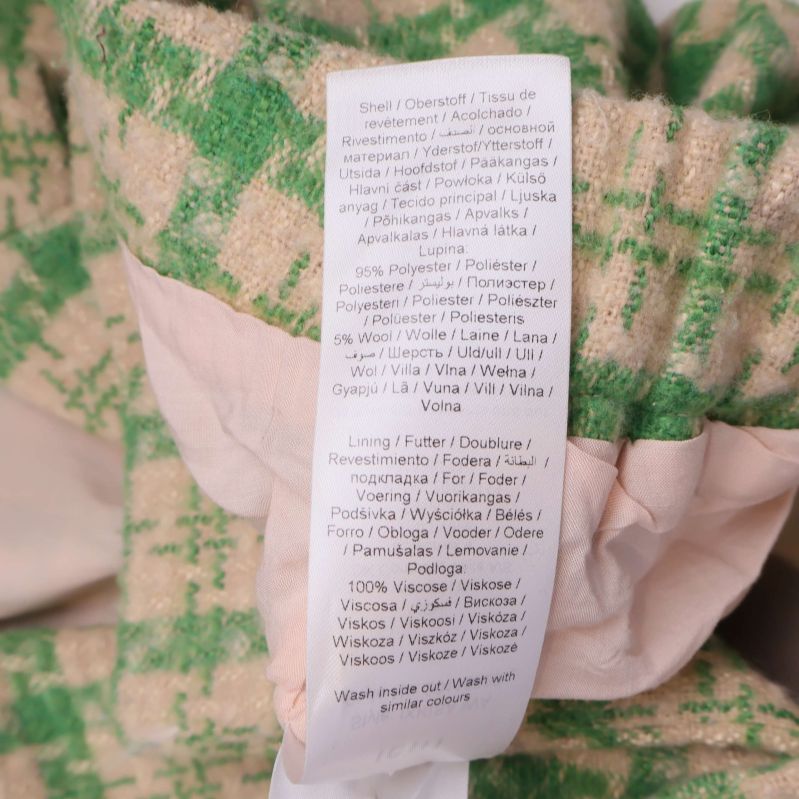 Detaljerad materialetikett i flera språk med materialprocent