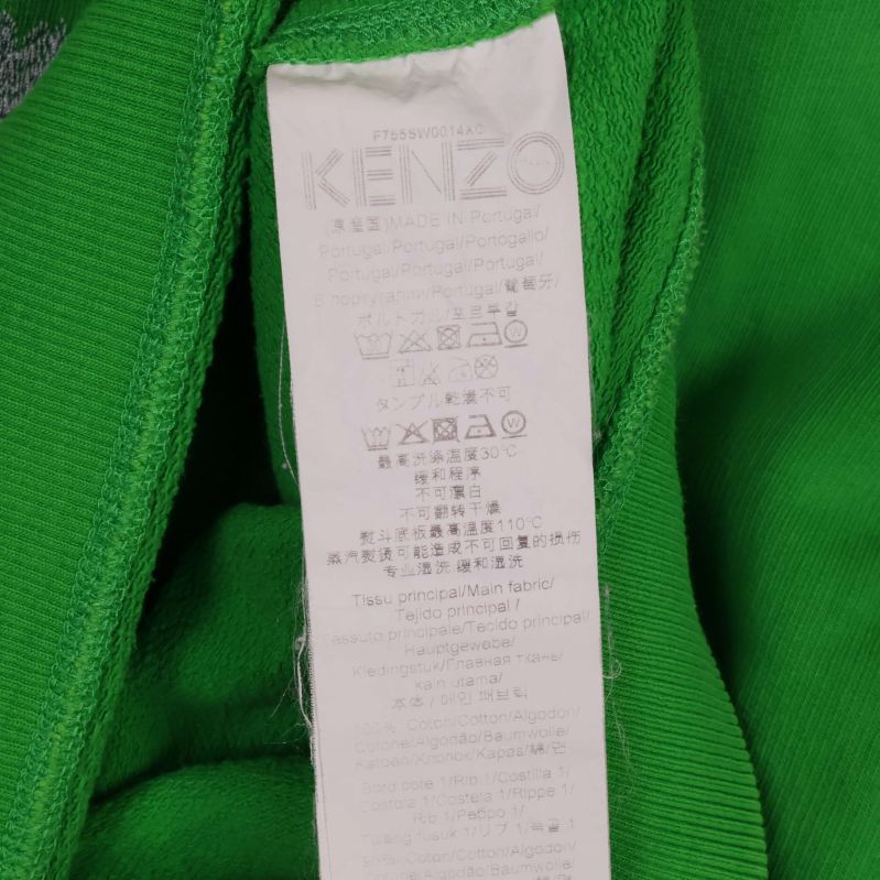 Tvättrådslapp med Kenzo-text och instruktioner