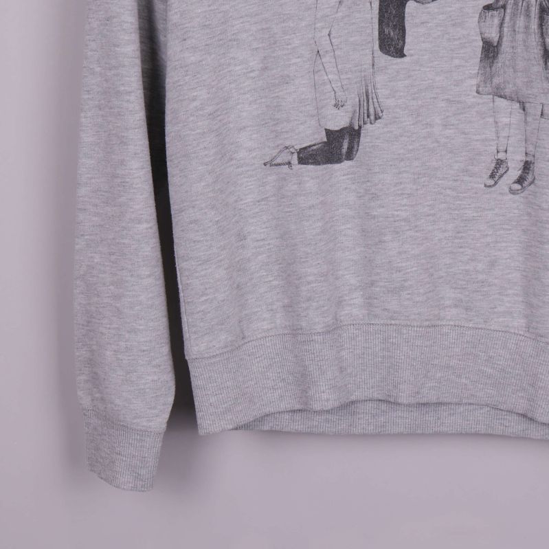 Närbild på ärm och nederkant av grå sweatshirt
