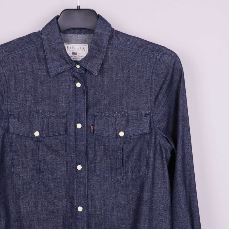 Bröstficka och knappdetaljer på denimskjorta