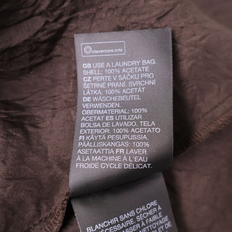 Materiallapp med information: 100% acetat