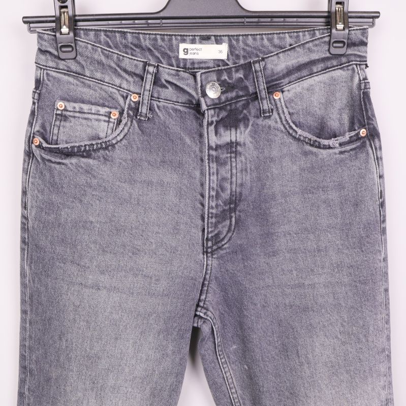 Detalj på fickor och midja framtill på grå jeans